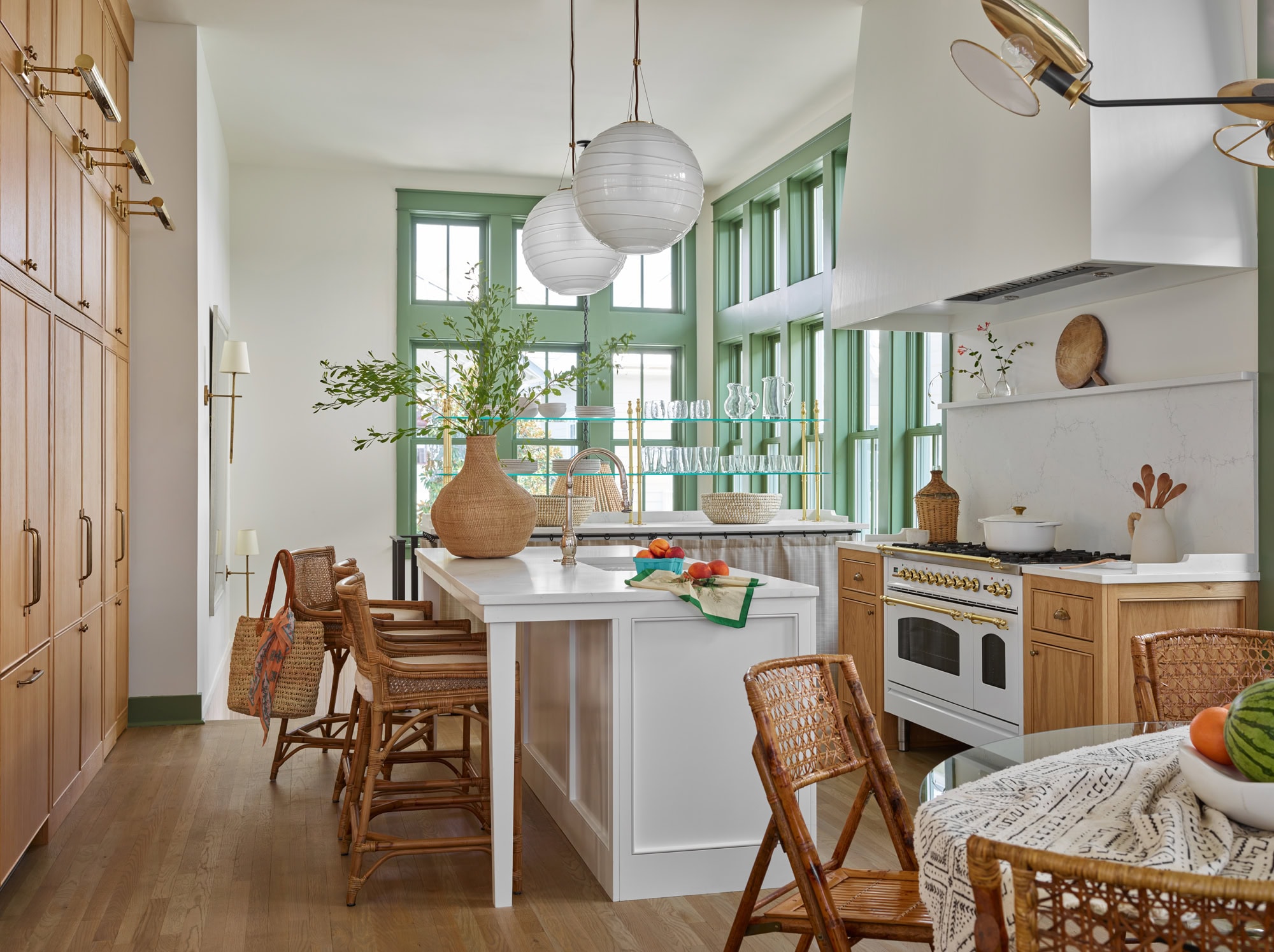 Designer Spotlight about Ashley Gilbreath Interiors Design project featuring a open concept kitchen with pops of green and rustic textures in a tropical style mixed with traditional and modern home accents.