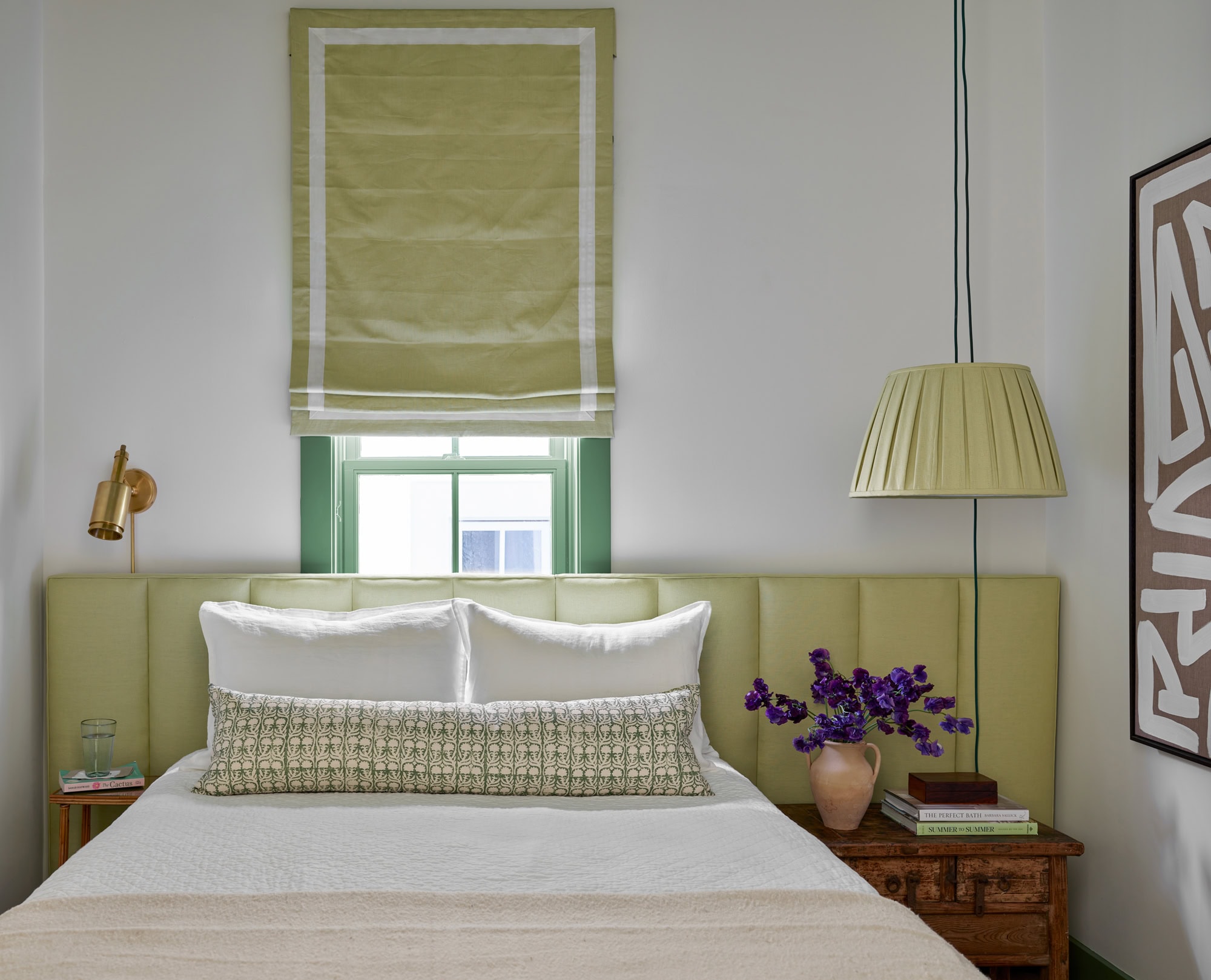 Designer Spotlight about Ashley Gilbreath Interiors Design project featuring a bedroom with pops of green and rustic textures in a tropical style mixed with traditional and modern home accents.