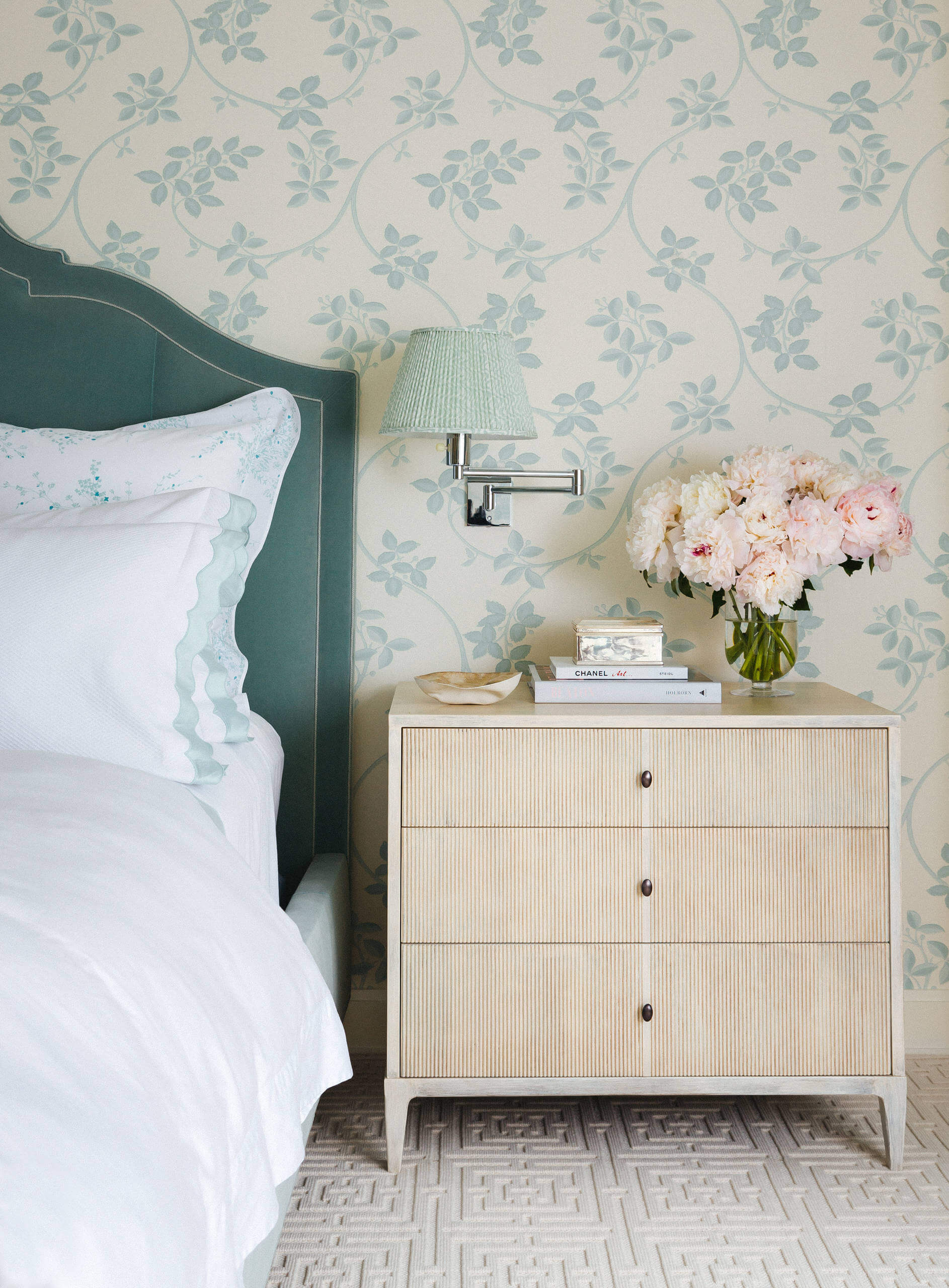 Chic bedroom with serene aqua walls. Large bed and ivory rugs work as the focal points. Transitional aesthetic with sophisticated ambiance.