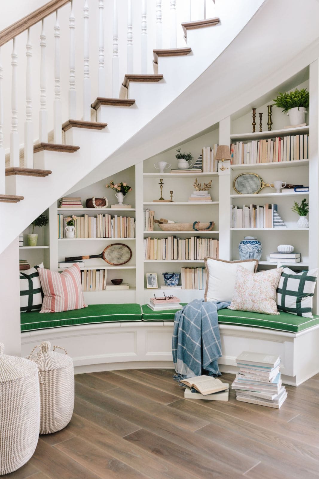 Reading nook under open staircase in a classic fresh traditional decor style by Bria Hammel Interiors