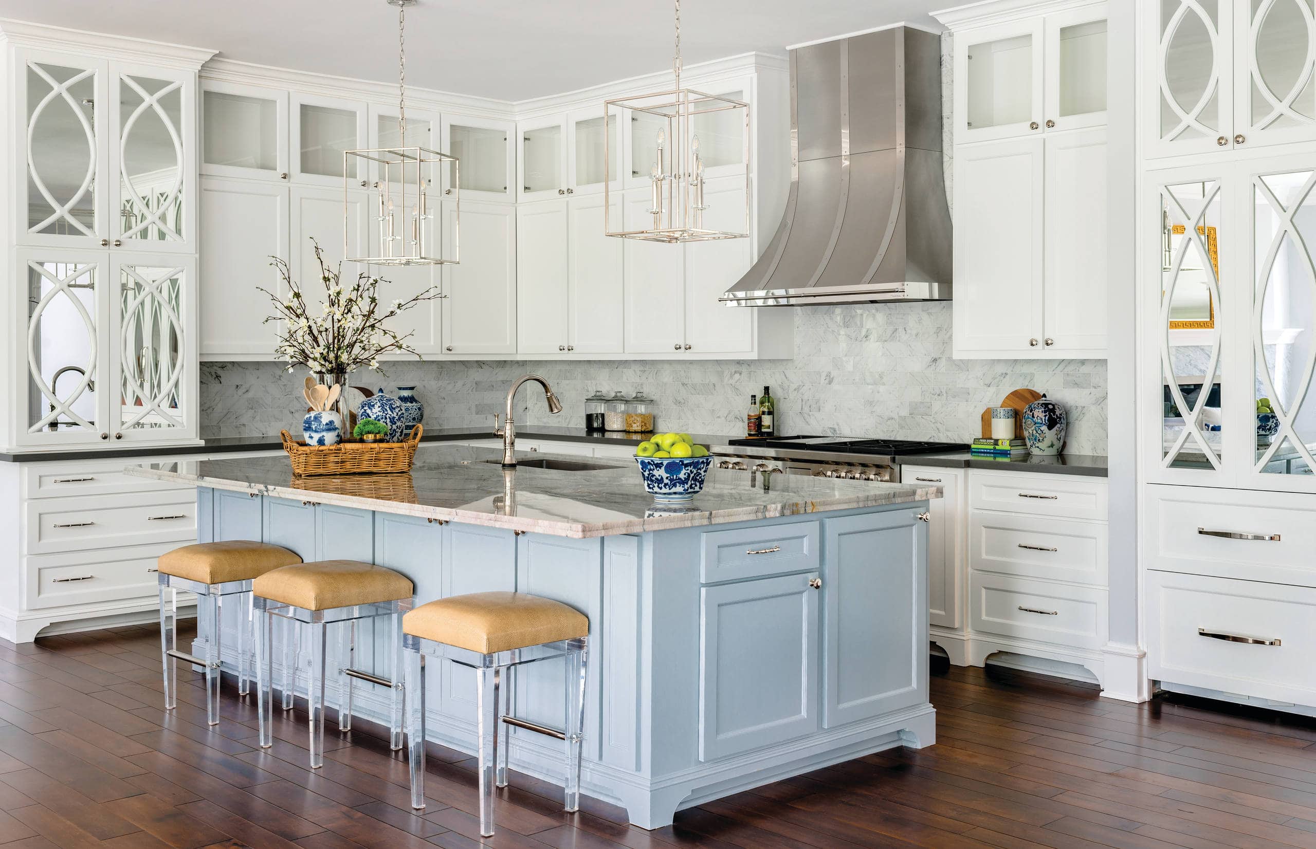 Modern traditional coastal kitchen island in light blue featured as part of focal point tips