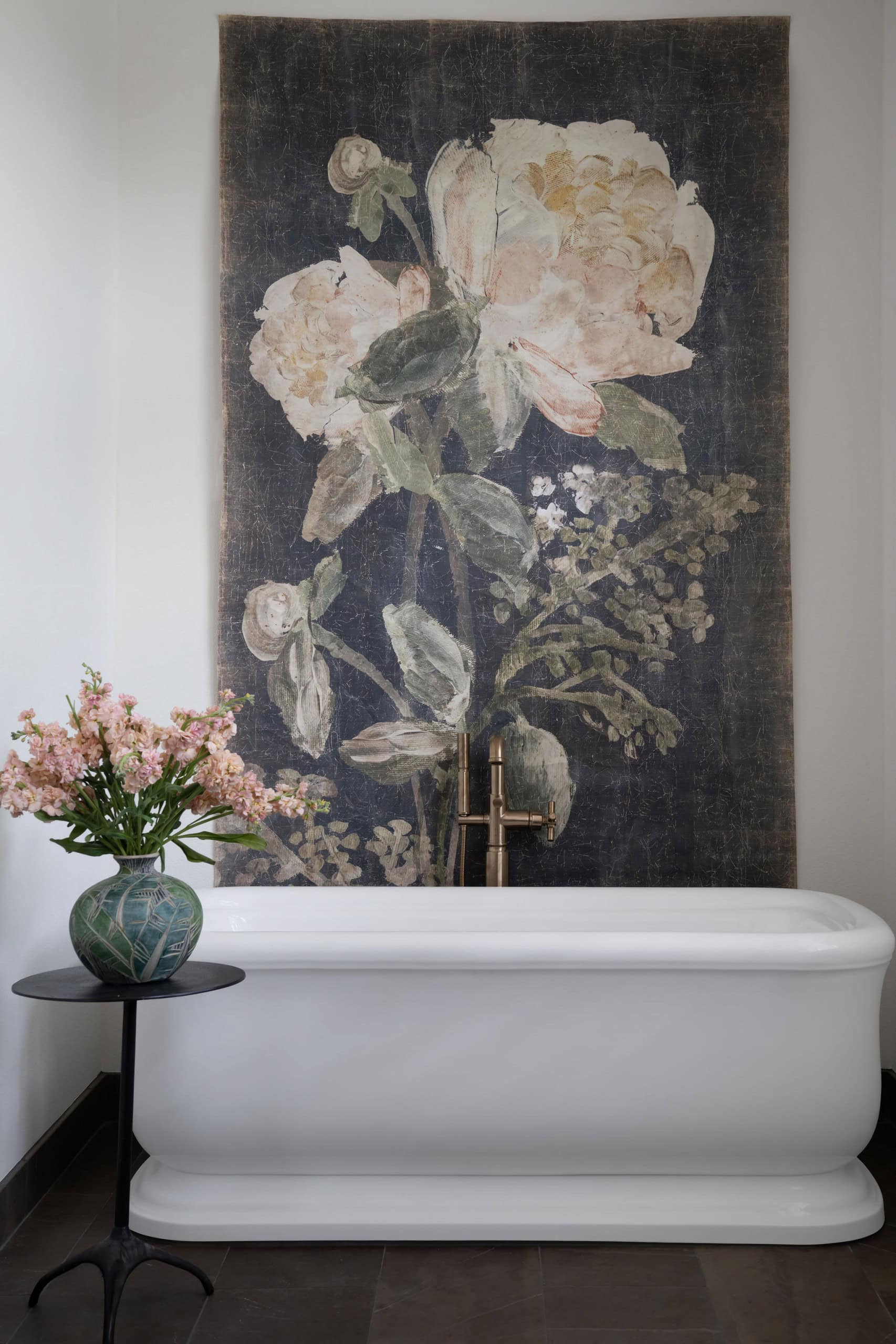 Transitional bathroom featuring floral art painting against tub as part of focal point tips