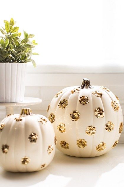 Creative no carve pumpkin decorating idea featuring white pumpkins with glitter polka dots in gold
