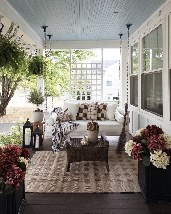 Example of fall porch decorations featuring a front porch with seating area