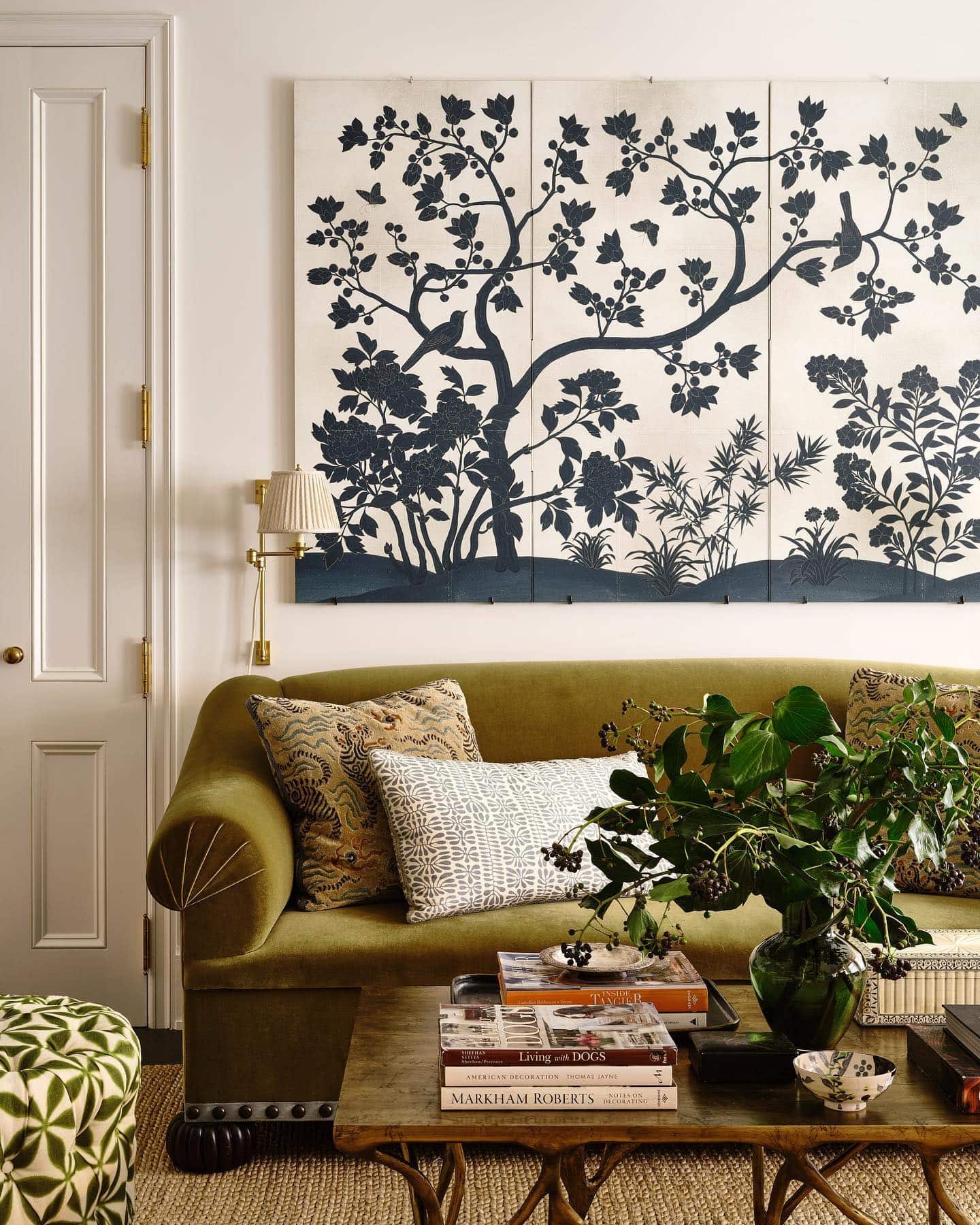 Fall decor for living room idea featuring botanical large print above green velvet sofa in traditional modern living room