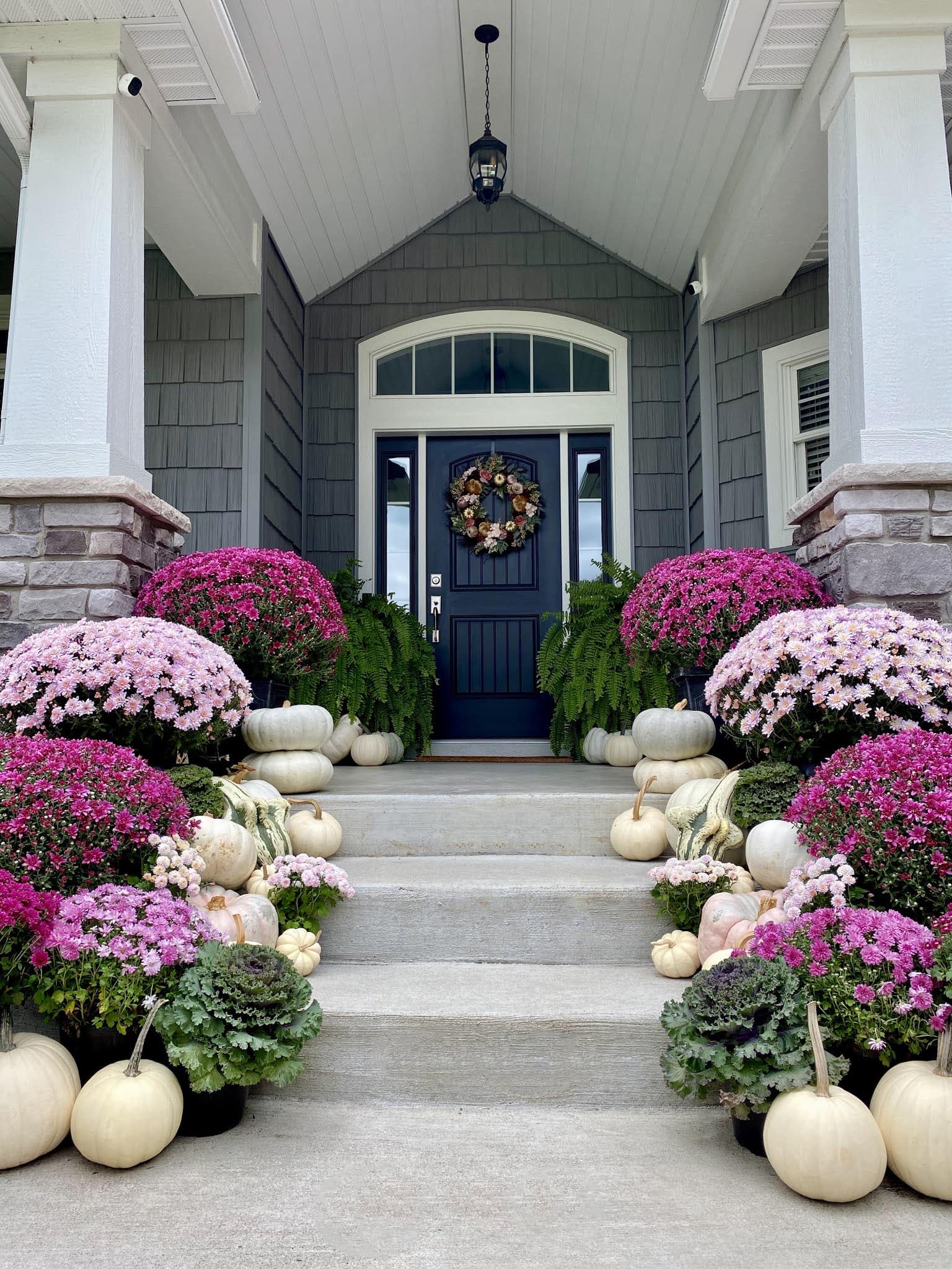 Example of fall porch decorations featuring a traditional pink and purple front porch
