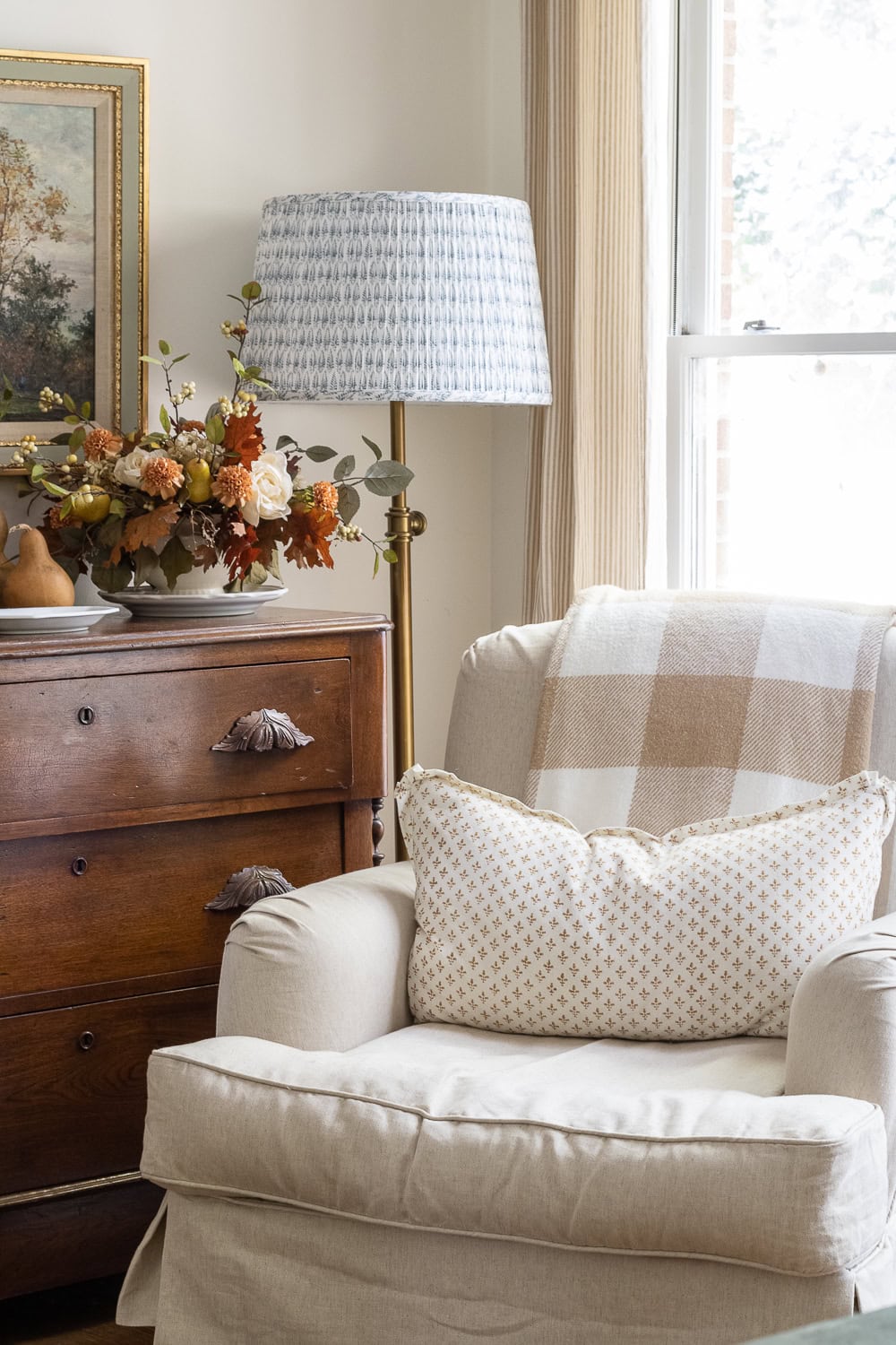 Fall decor for living room idea featuring neutral armchair in traditional modern living room