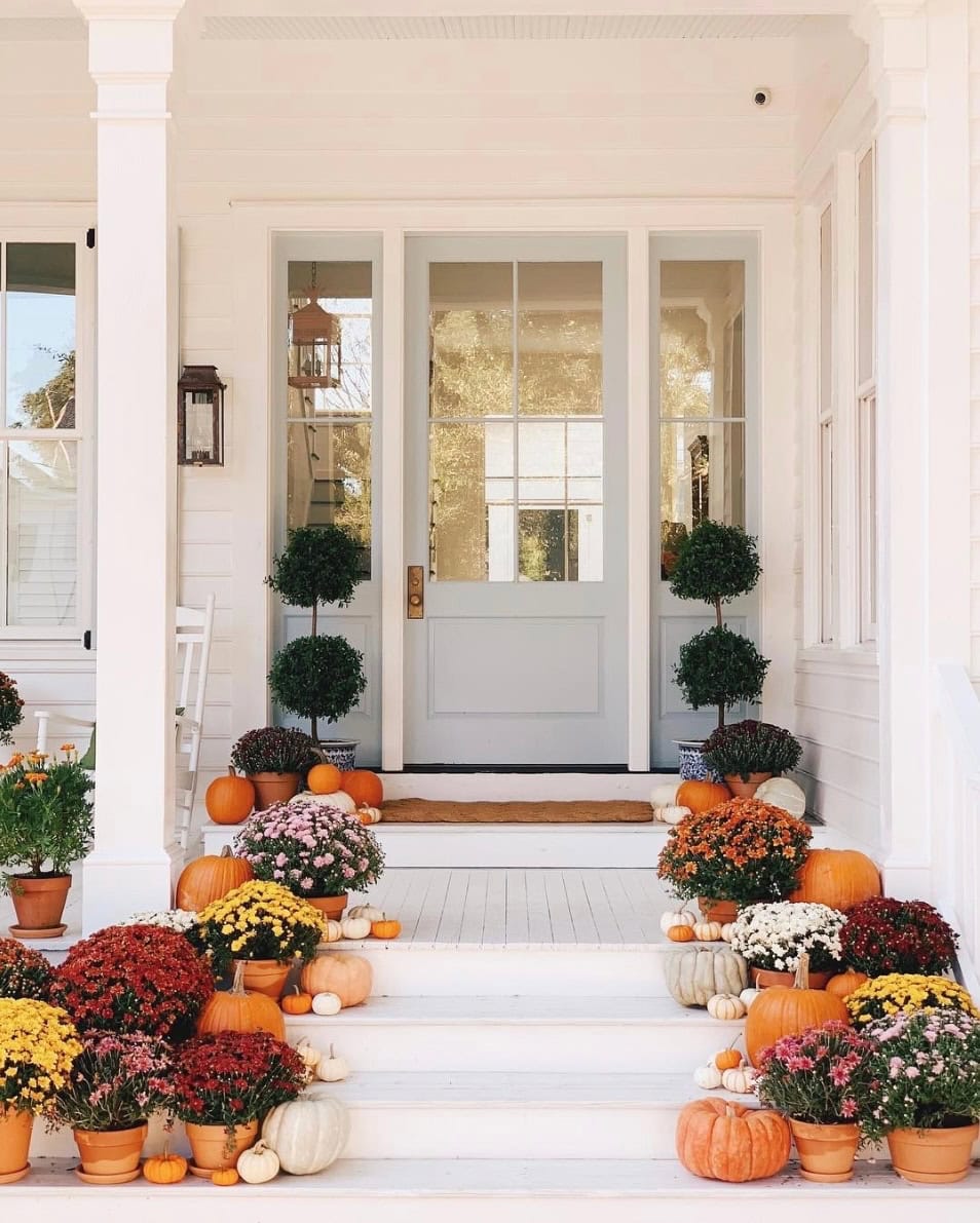 Example of fall porch decorations featuring a traditional front door porch