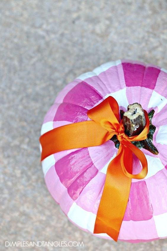 Creative no carve pumpkin decorating idea featuring pumpkin handpainted in checks pattern in pink and white