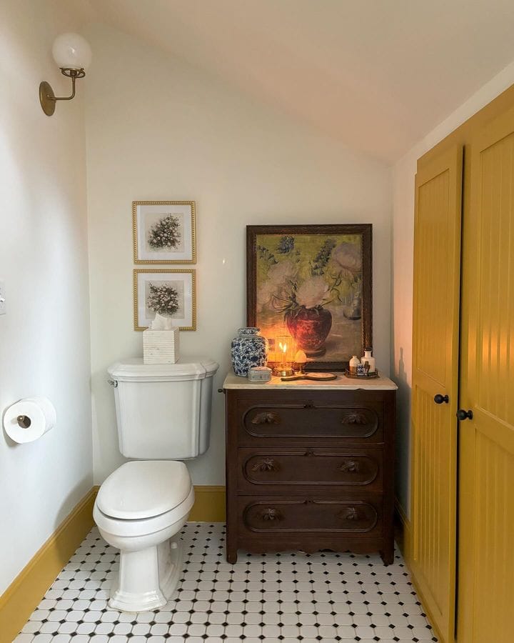 Fall bathroom decor idea featuring yellow closet door and dark antique furniture