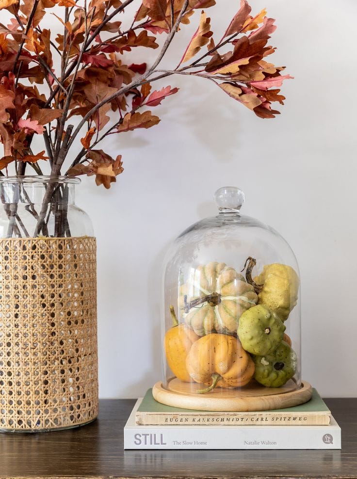 Example of minimalist fall decor ideas featuring fall decor and orange branches in vase