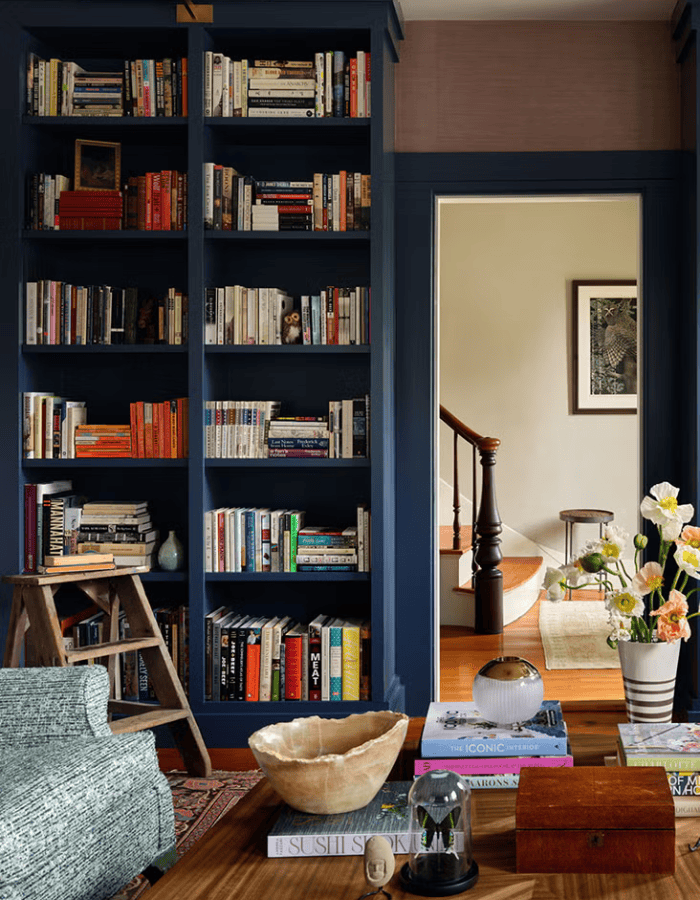 Fall decor for living room idea featuring built in bookcase in blue