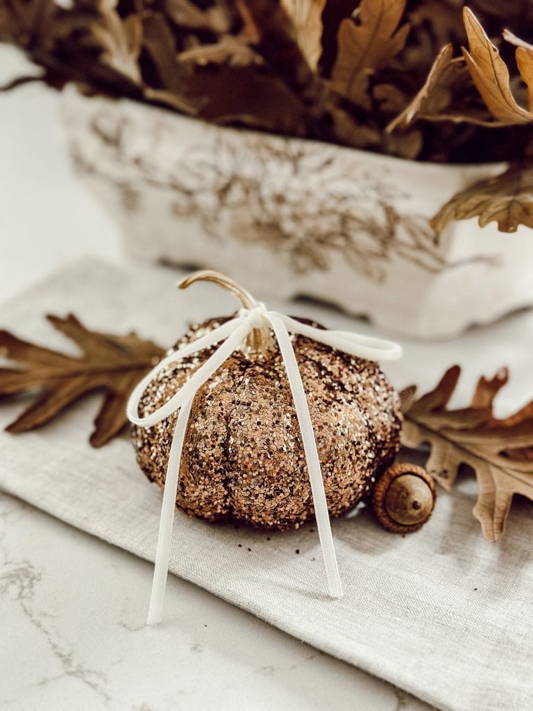 Creative no carve pumpkin decorating idea featuring brown and bronze glitter covered pumpkin