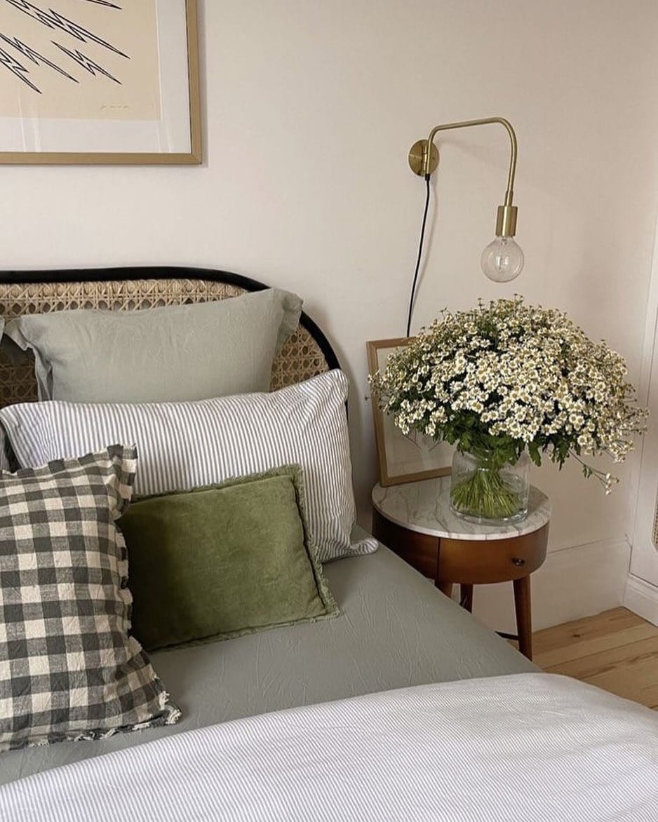 Example of throw pillow combo in cottage-inspired bedroom in green color scheme