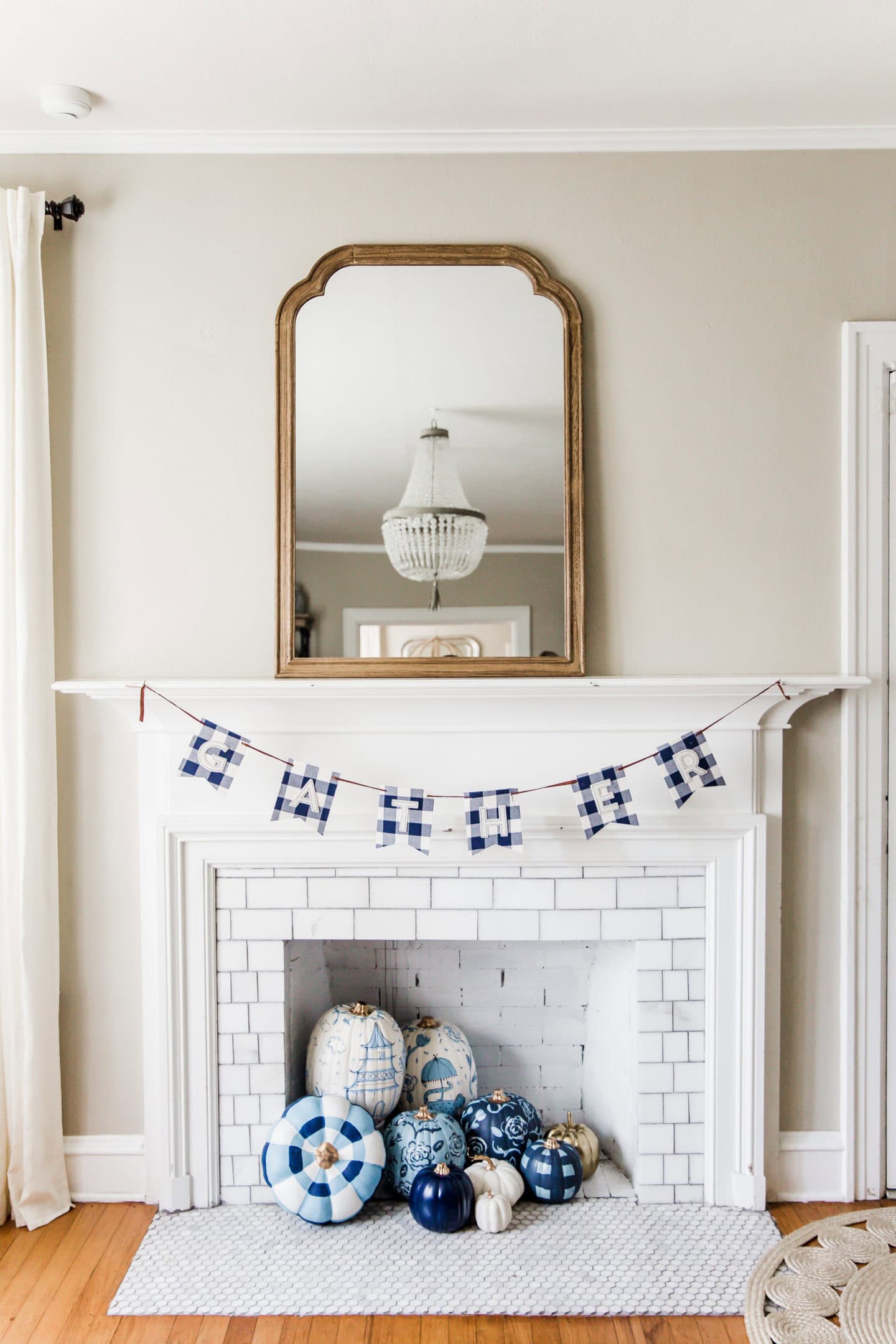 Fall decor idea featuring coastal styled living room with blue pumpkins on mantle