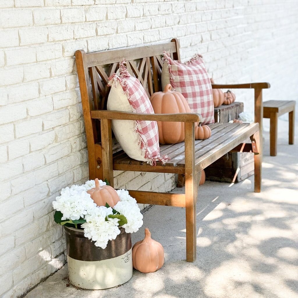 Example of fall porch decorations featuring a front porch with seating area