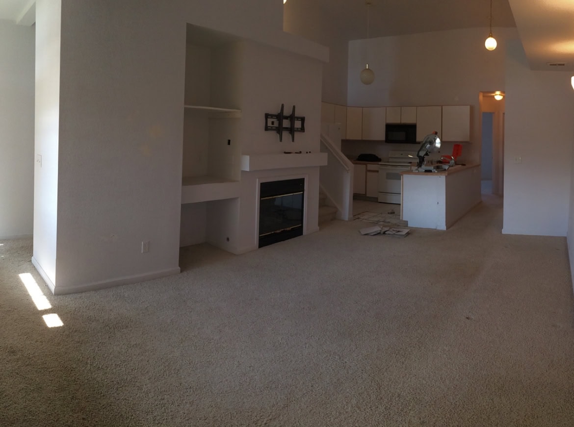 Outdated kitchen with original cabinets, carpet flooring, and no backsplash in a Colorado condo before the DIY renovation.