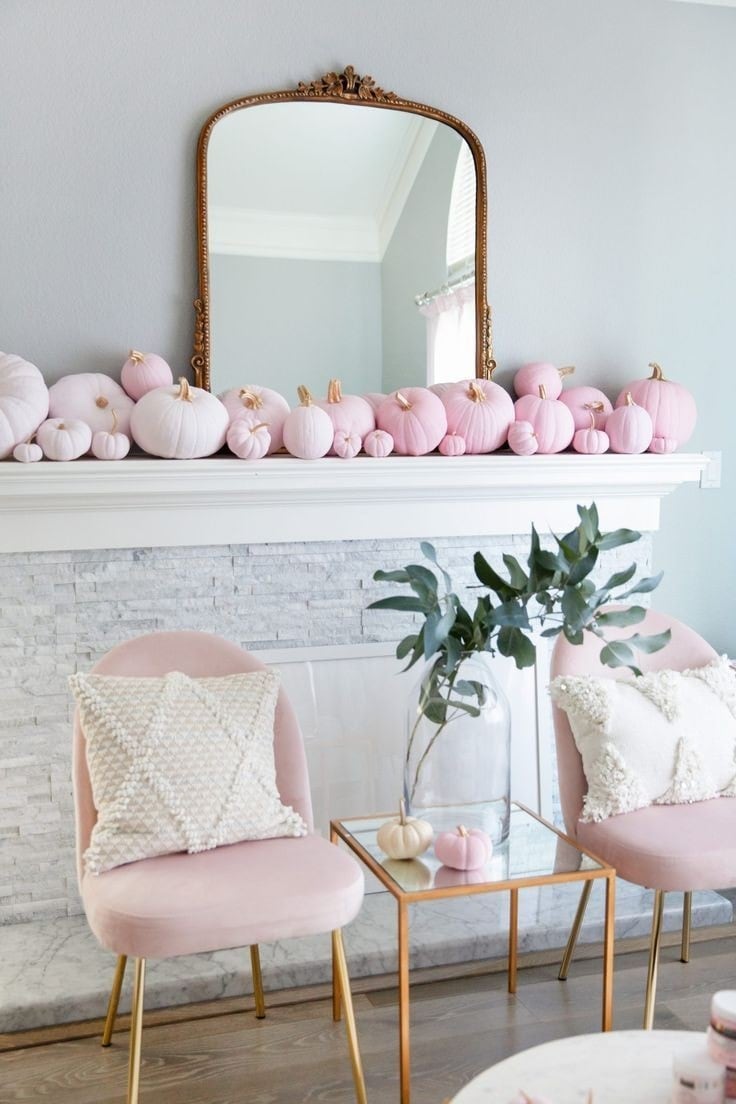 Pink Halloween decorations example featuring an elegant mantle with pink pumpkins