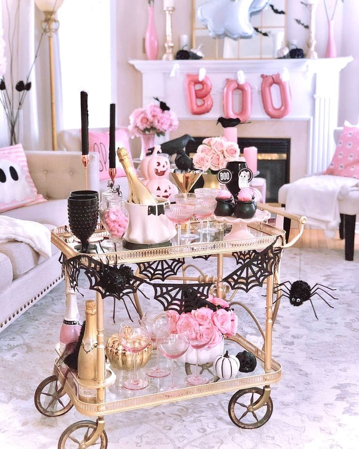 Pink Halloween decorations example featuring a bar cart with pink and black accents