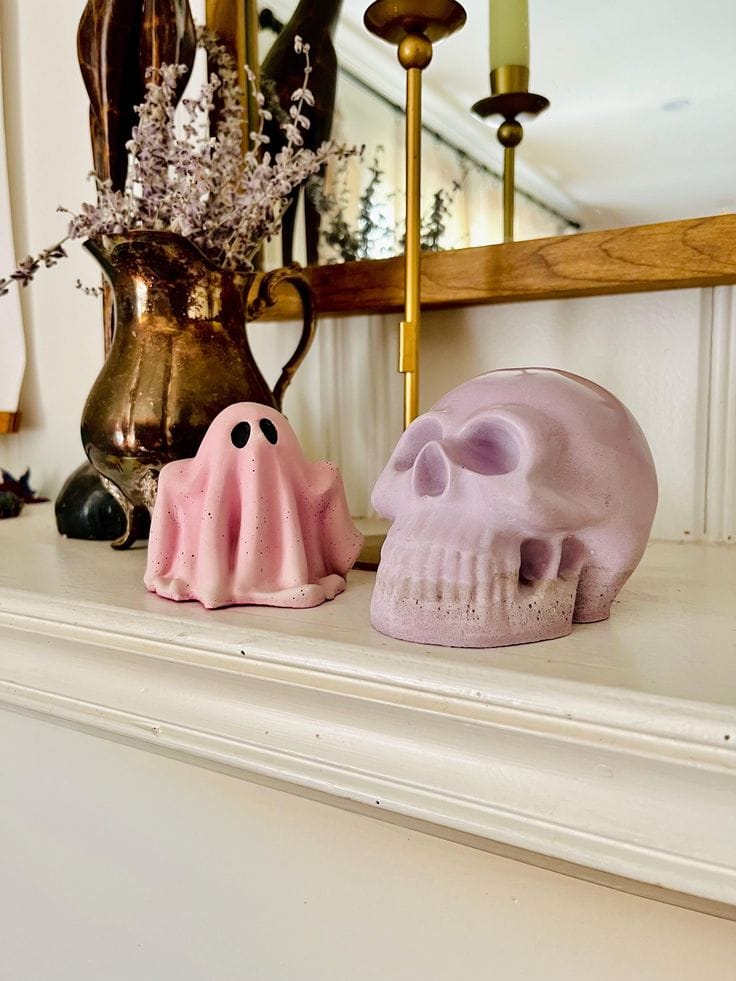 Pink Halloween decorations example featuring a mantle with pink and purple candle pumpkins
