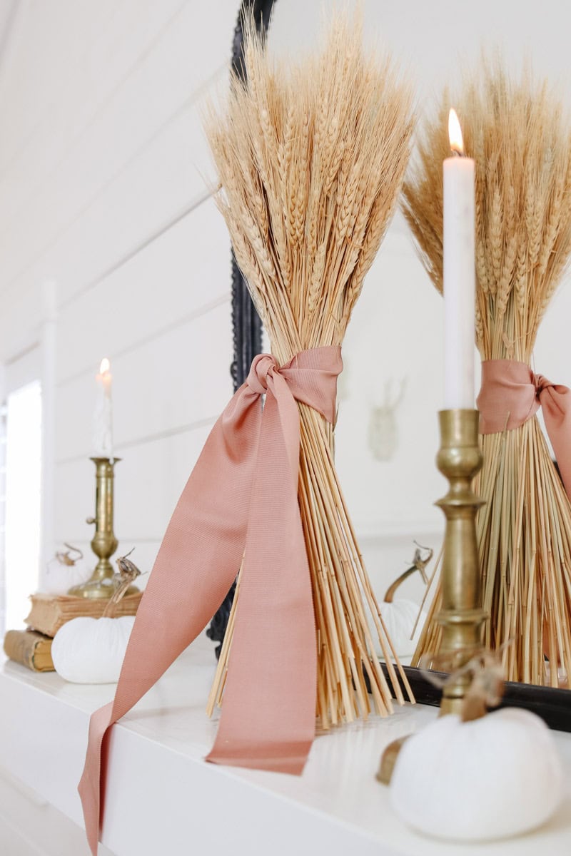 Pink Halloween decorations example featuring a mantle with dried wheat grass with pink ribbon