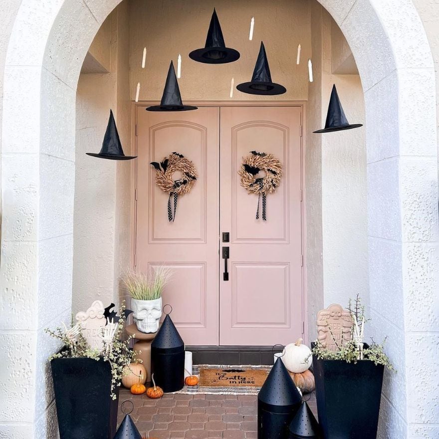 Pink Halloween decorations example featuring an entryway with pale pink and black decor