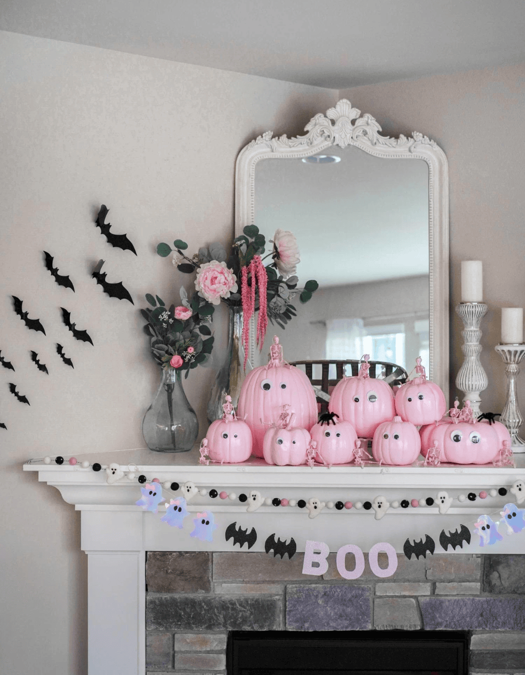 Pink Halloween decorations example featuring an elegant mantle with pink pumpkins and little black bats