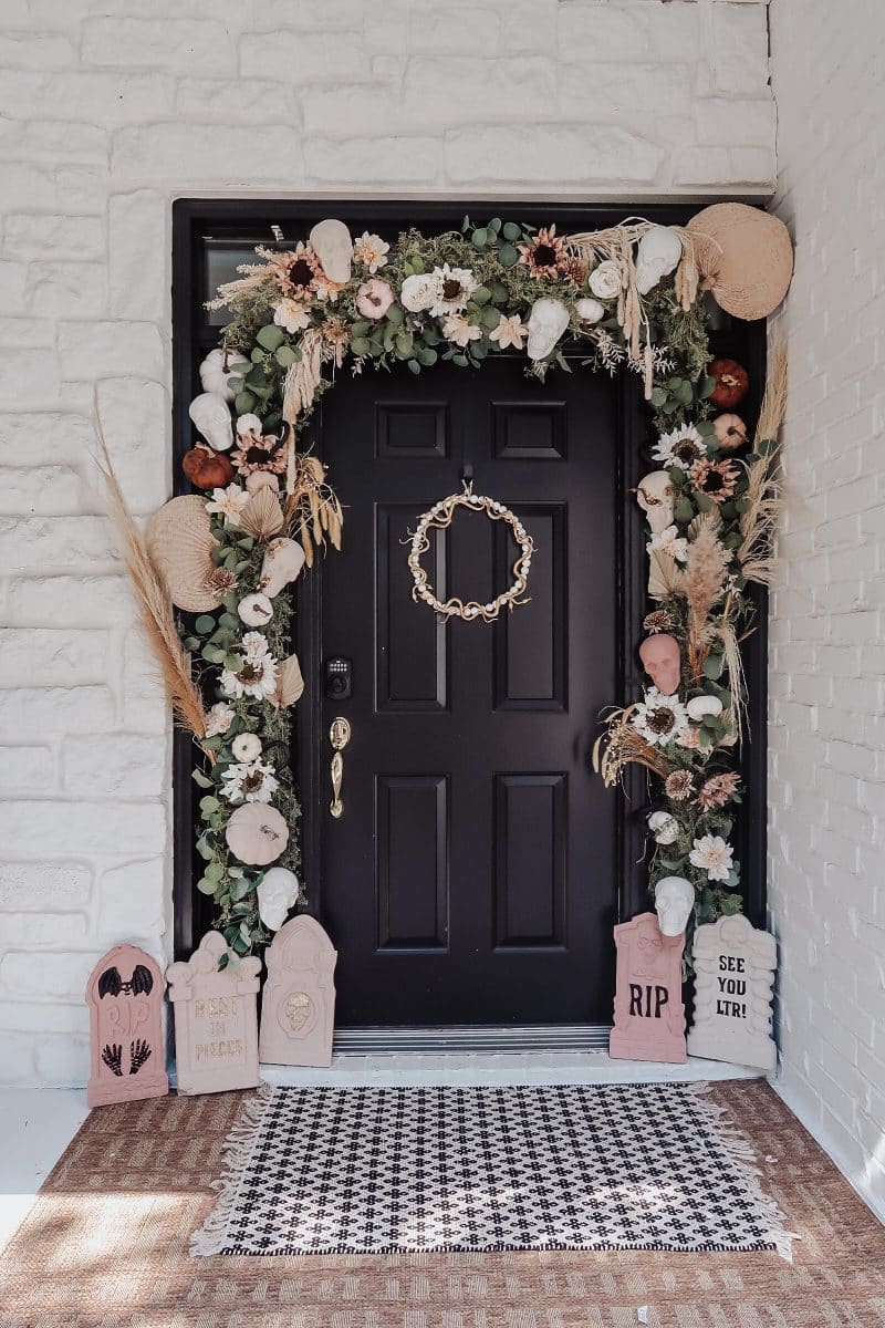 Pink Halloween decorations example featuring an entryway with black door and palee pink decor