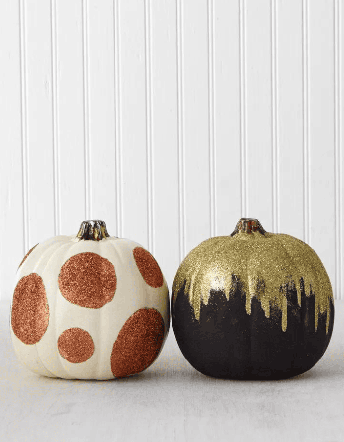 Creative no carve pumpkin decorating idea featuring black and white pumpkins with glitter paint design