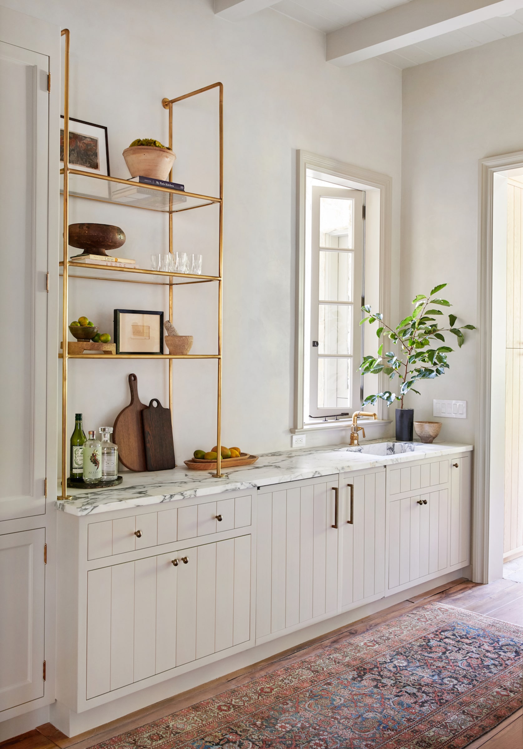 Example of kitchen in transitional style of how to mix metals when decorating