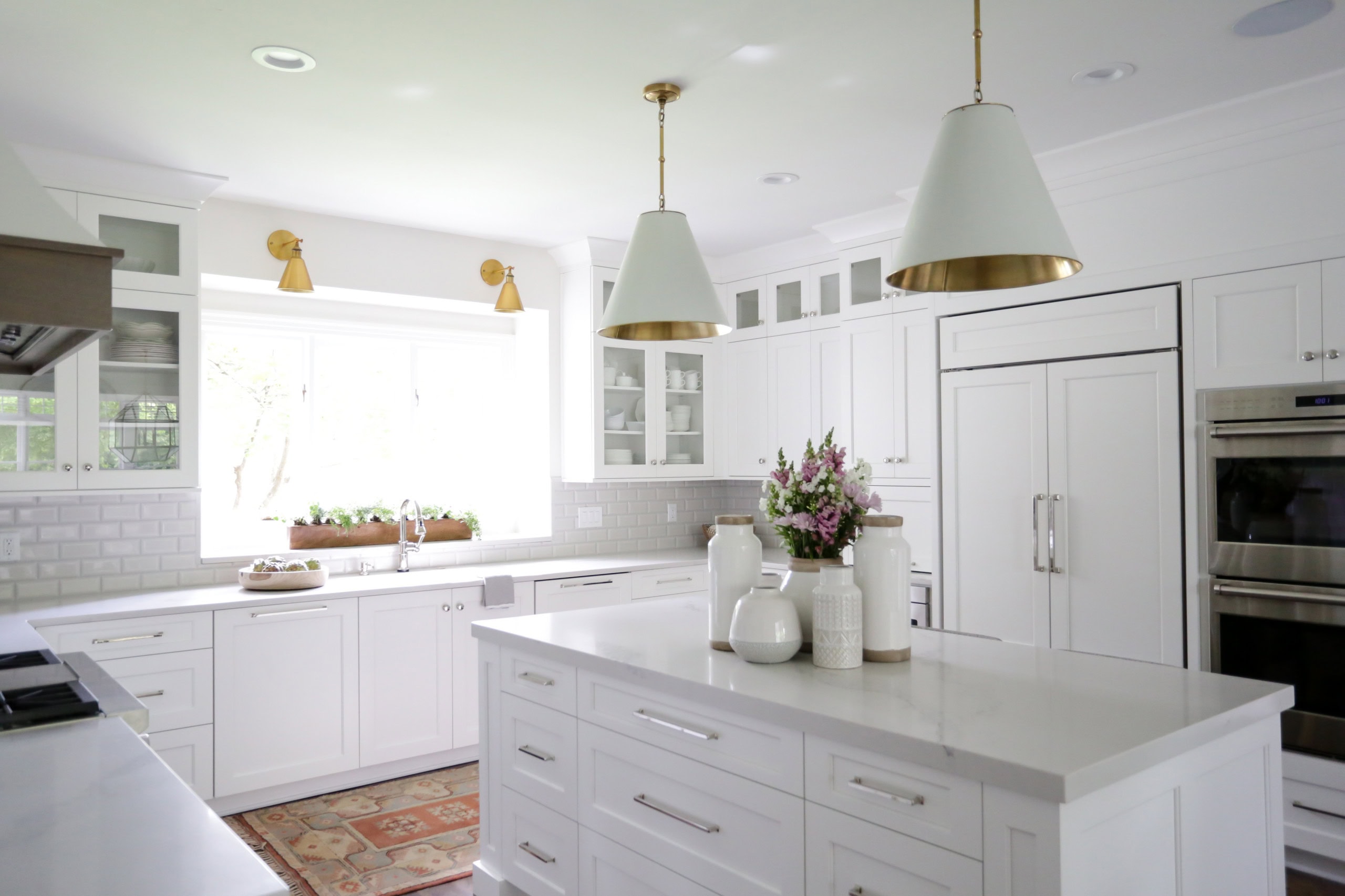 Example of kitchen in transitional style of how to mix metals when decorating