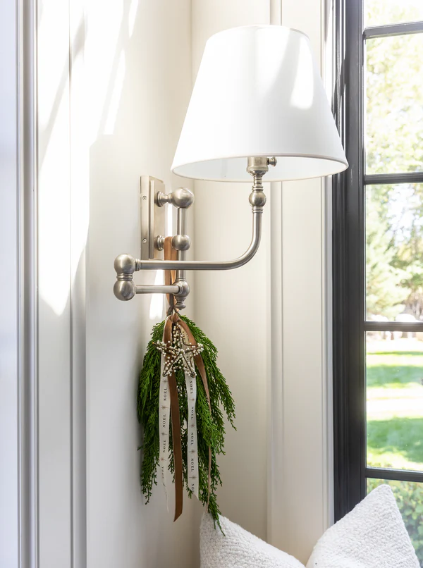 Charming apartment Christmas decorations and tips, example of hallway scone lamp with holiday decor
