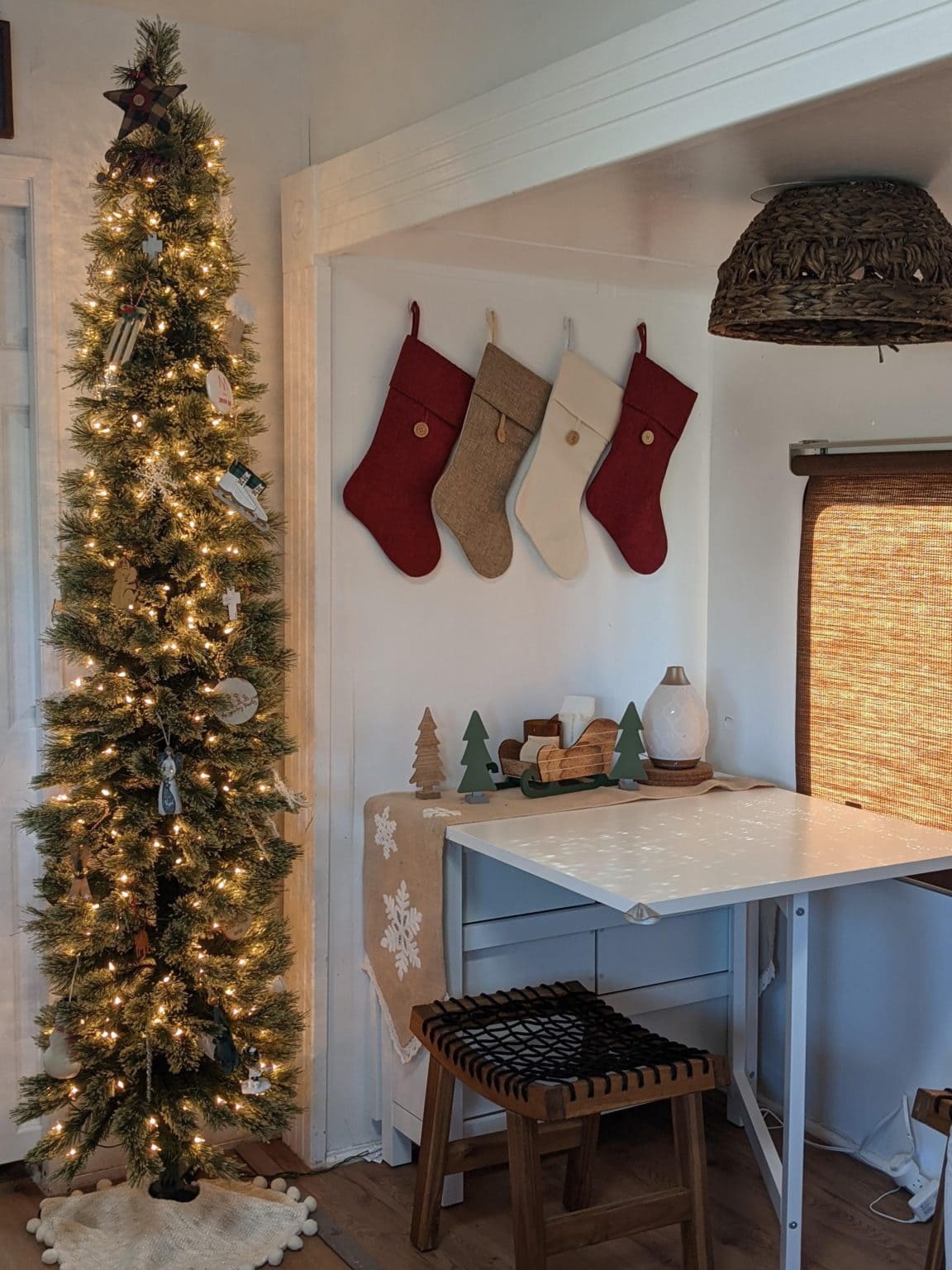 Charming apartment Christmas decorations and tips, example of small dining area with tree.