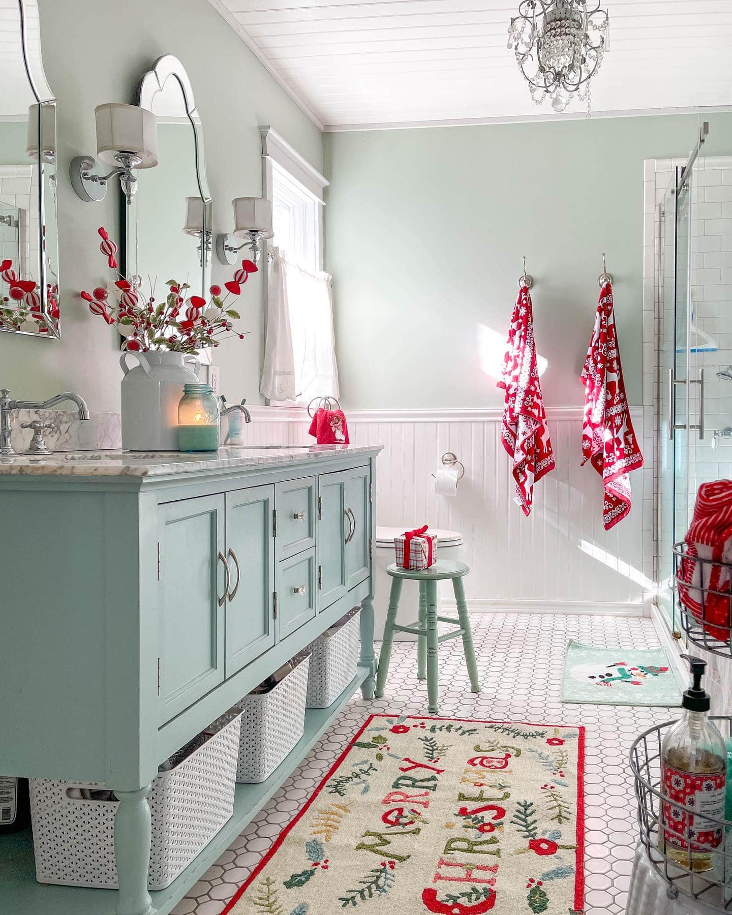 Ideas and tips for Christmas bathroom decor featuring a bathroom with modern style, showcasing light blue accents and red Christmas decor.