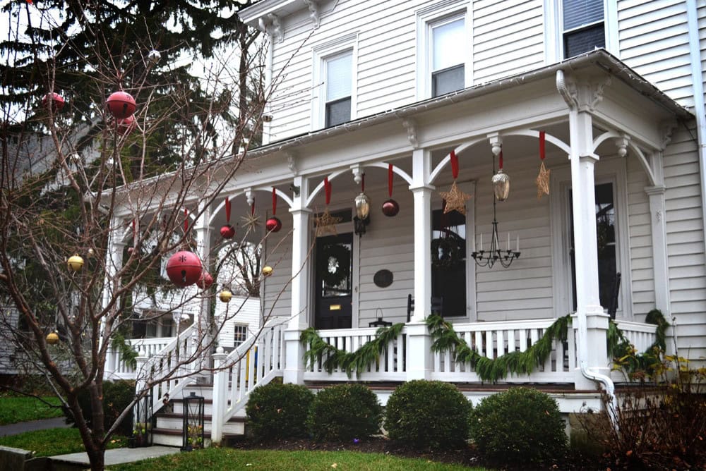 Create magical Christmas porch decor with these ideas example featuring a traditional decorated front porch facade