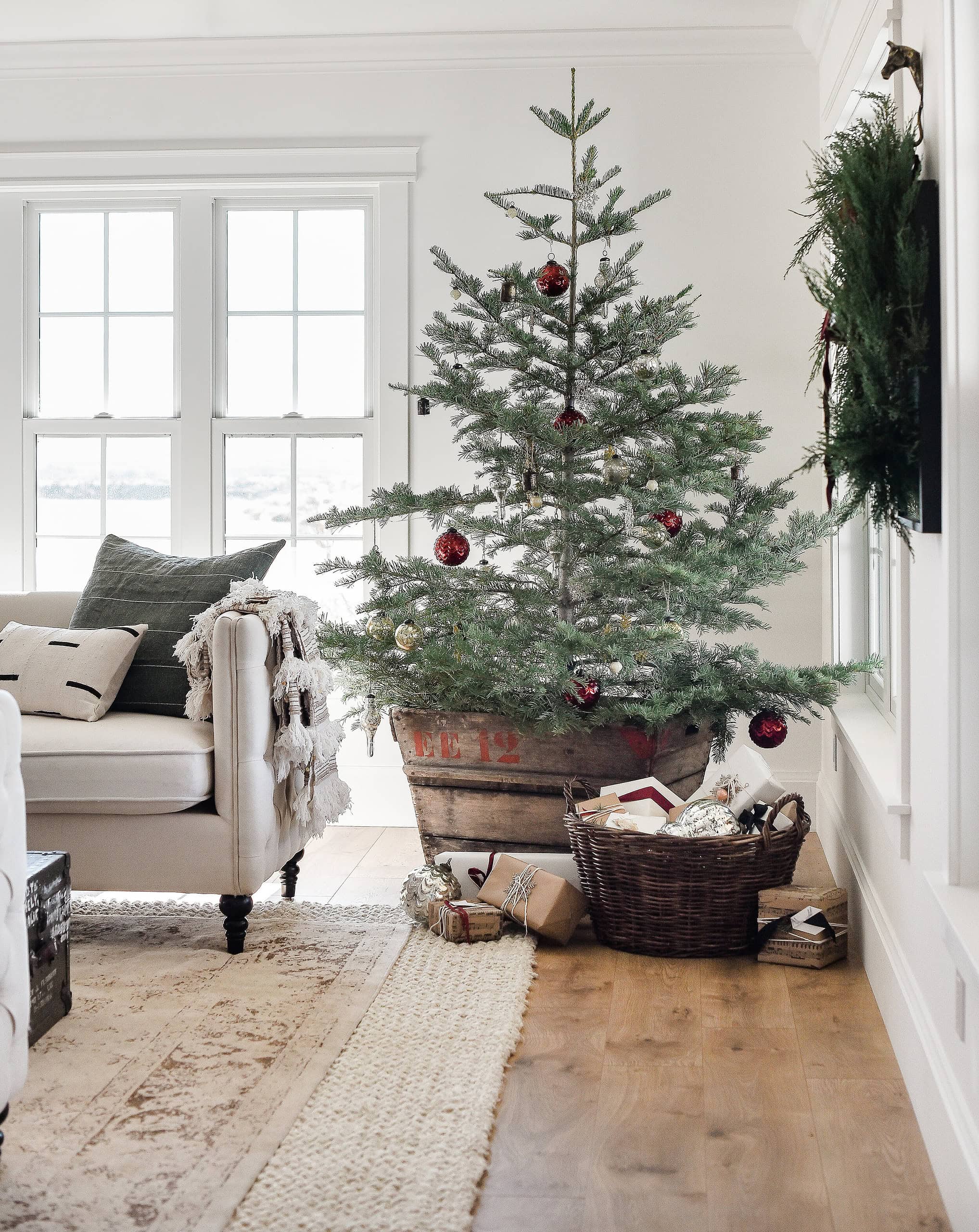 Example of cozy Christmas decor featuring living room decorated in farmhouse minimalist style.