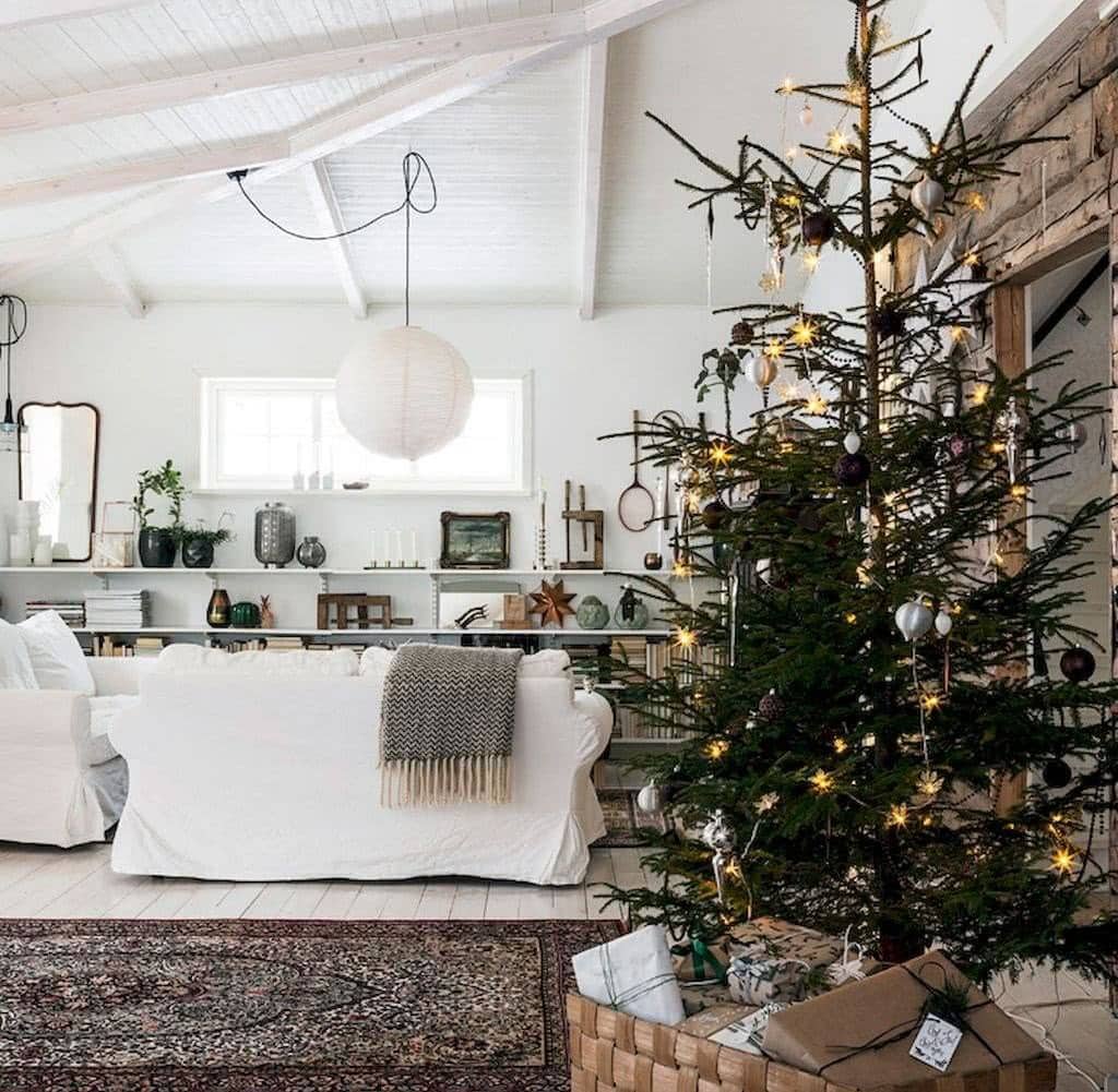 Example of cozy Christmas decor featuring living room decorated in farmhouse minimalist style.