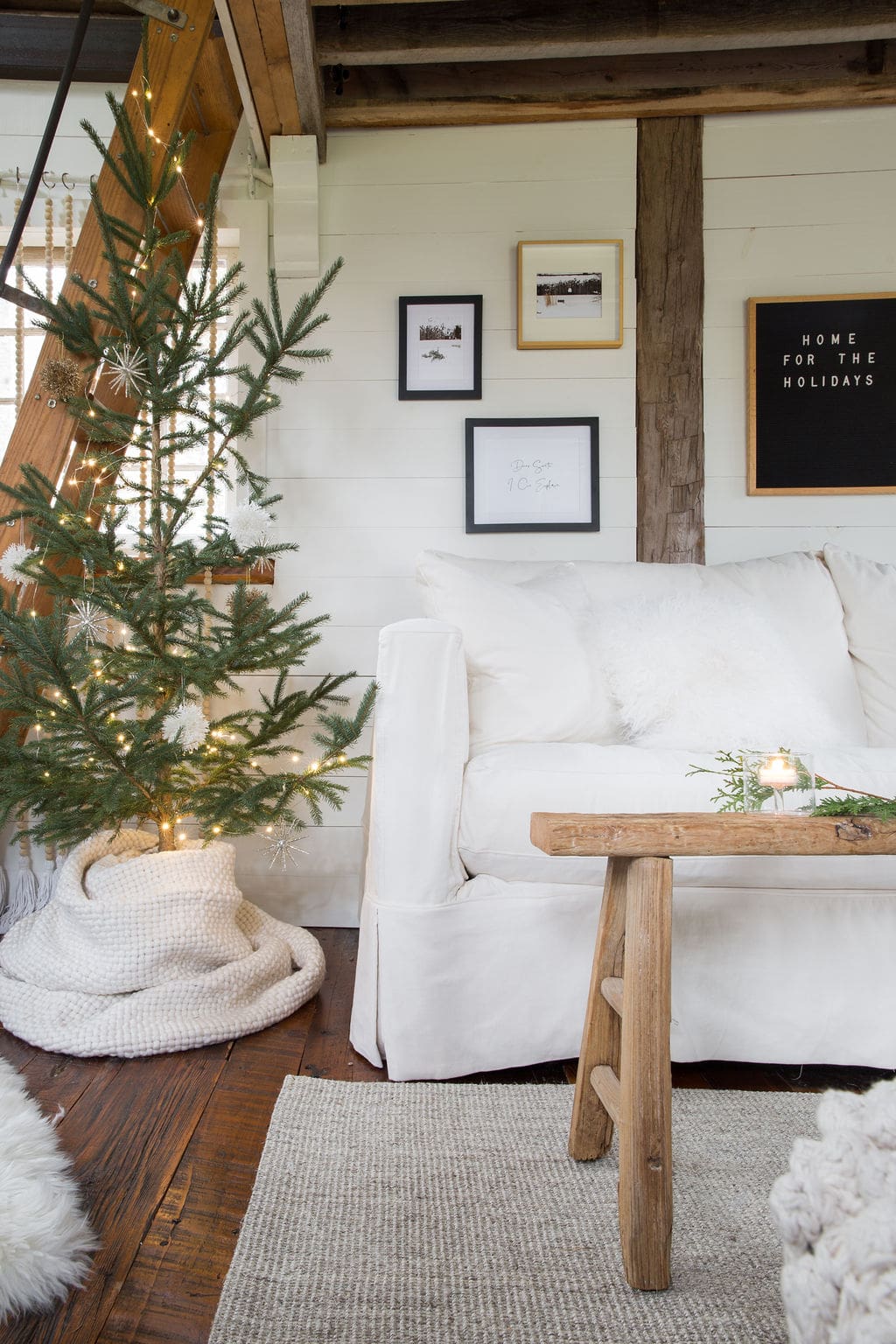 Example of cozy Christmas decor featuring living room decorated in scandi style.