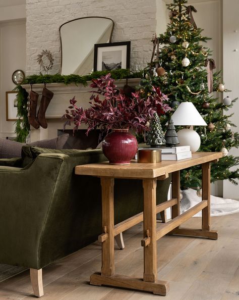 Example of cozy Christmas decor featuring living room decorated in traditional style.