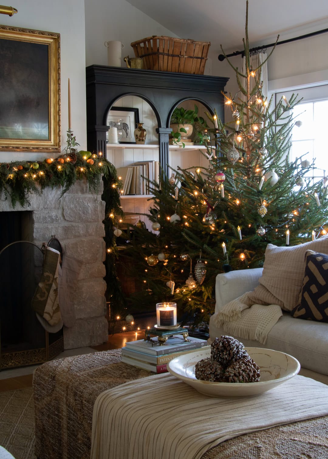 Cozy holiday living room with warm lights and décor.