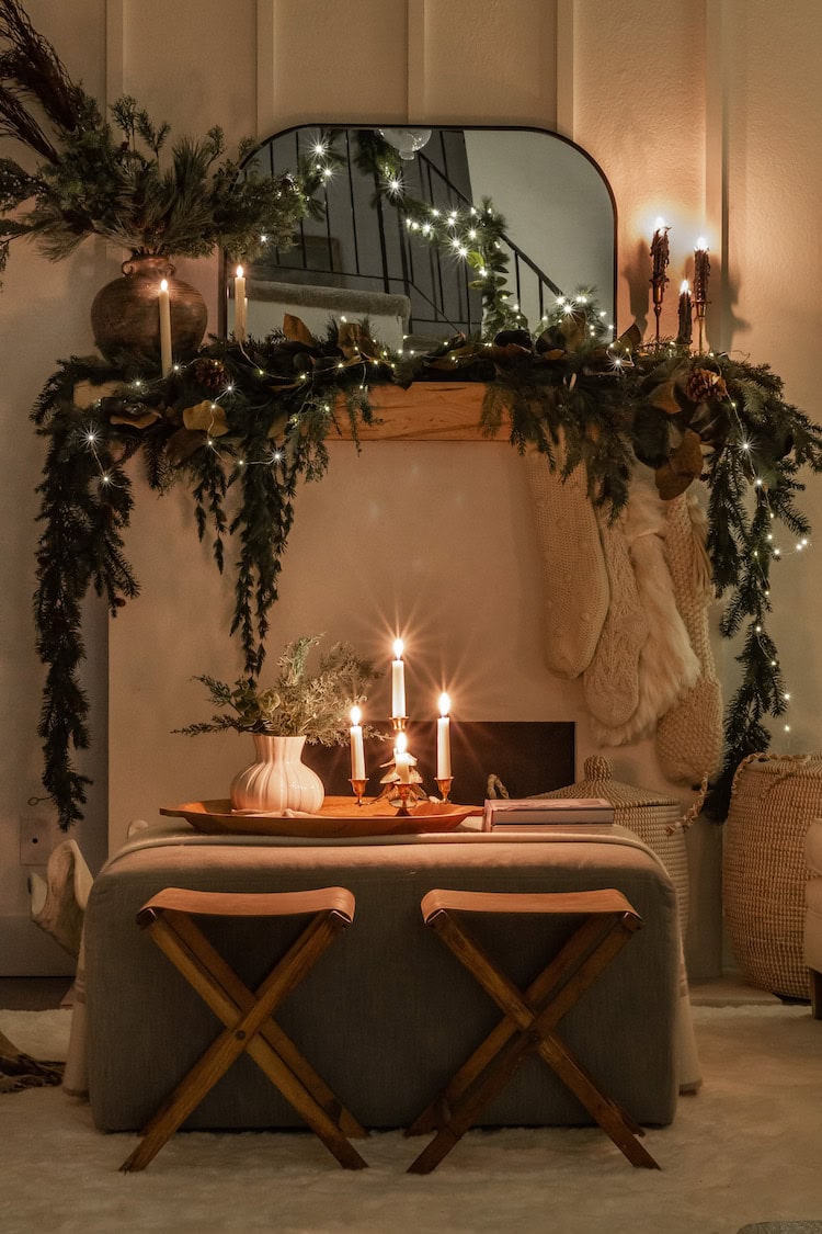 Example of cozy Christmas decor featuring living room decorated with garland in traditional style.