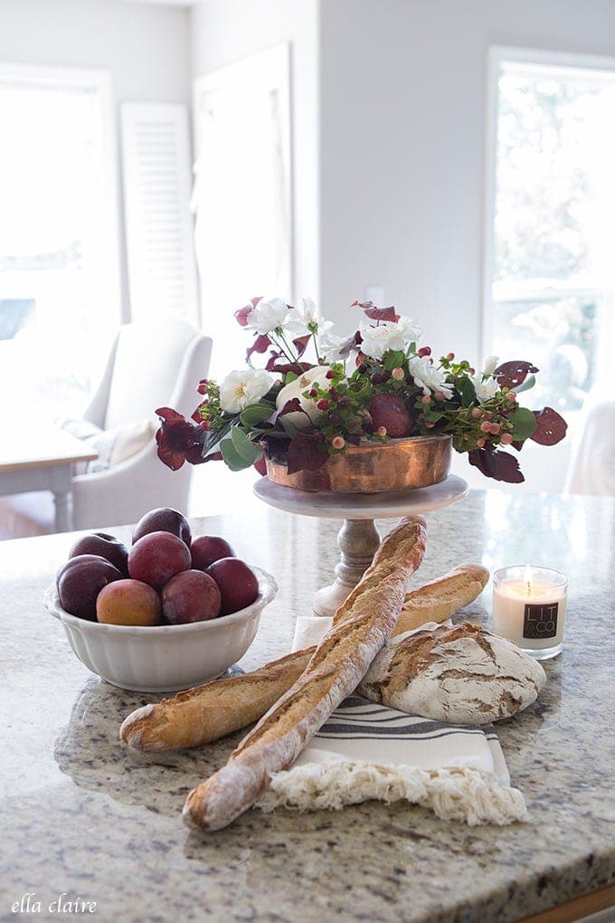 How to decorate for Thanksgiving example featuring fall floral arrangement placed on kitchen island