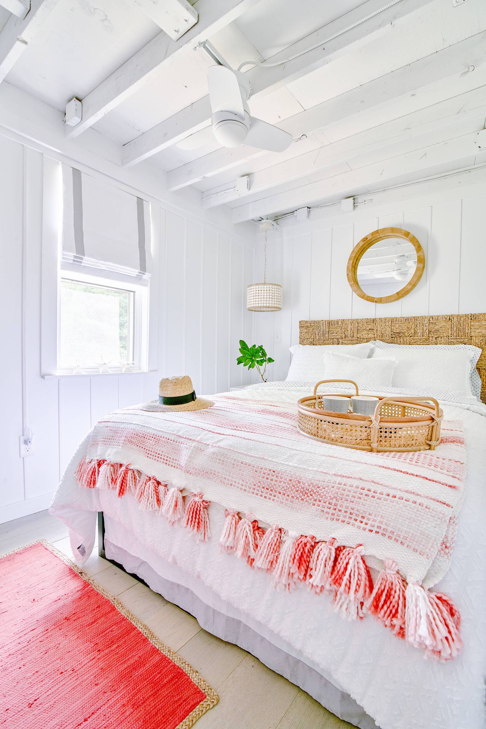 Guest room inspiration example showcasing a bed in a traditional coastal style in white and poops of color