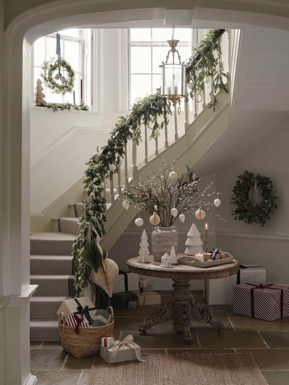 Christmas staircase decor idea featuring a sophisticated style entrance with a Christmas decor.