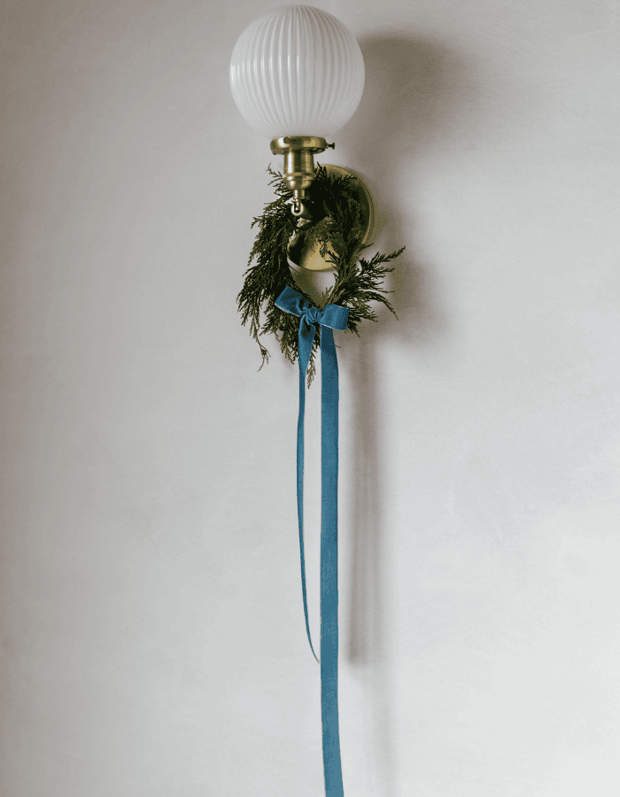 Christmas Wreath idea featuring a dark green wreath with blue velvet ribbon