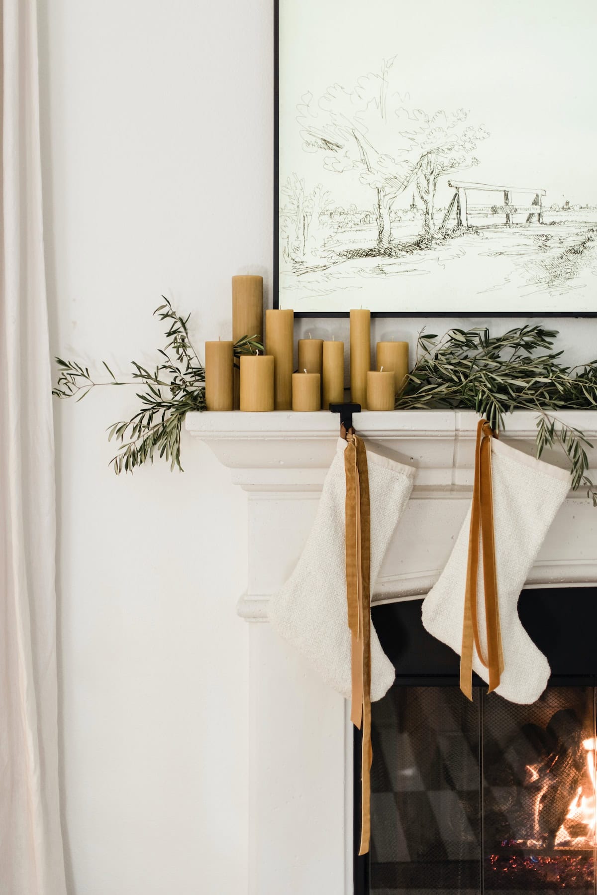 mantle showcasing transition from Thanksgiving to Christmas decor featuring a candles and garlands