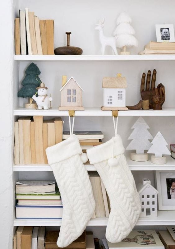 Christmas Stocking Holder Ideas for a Cozy Display Without a Fireplace featuring a stockings hanging from white shelves in modern style