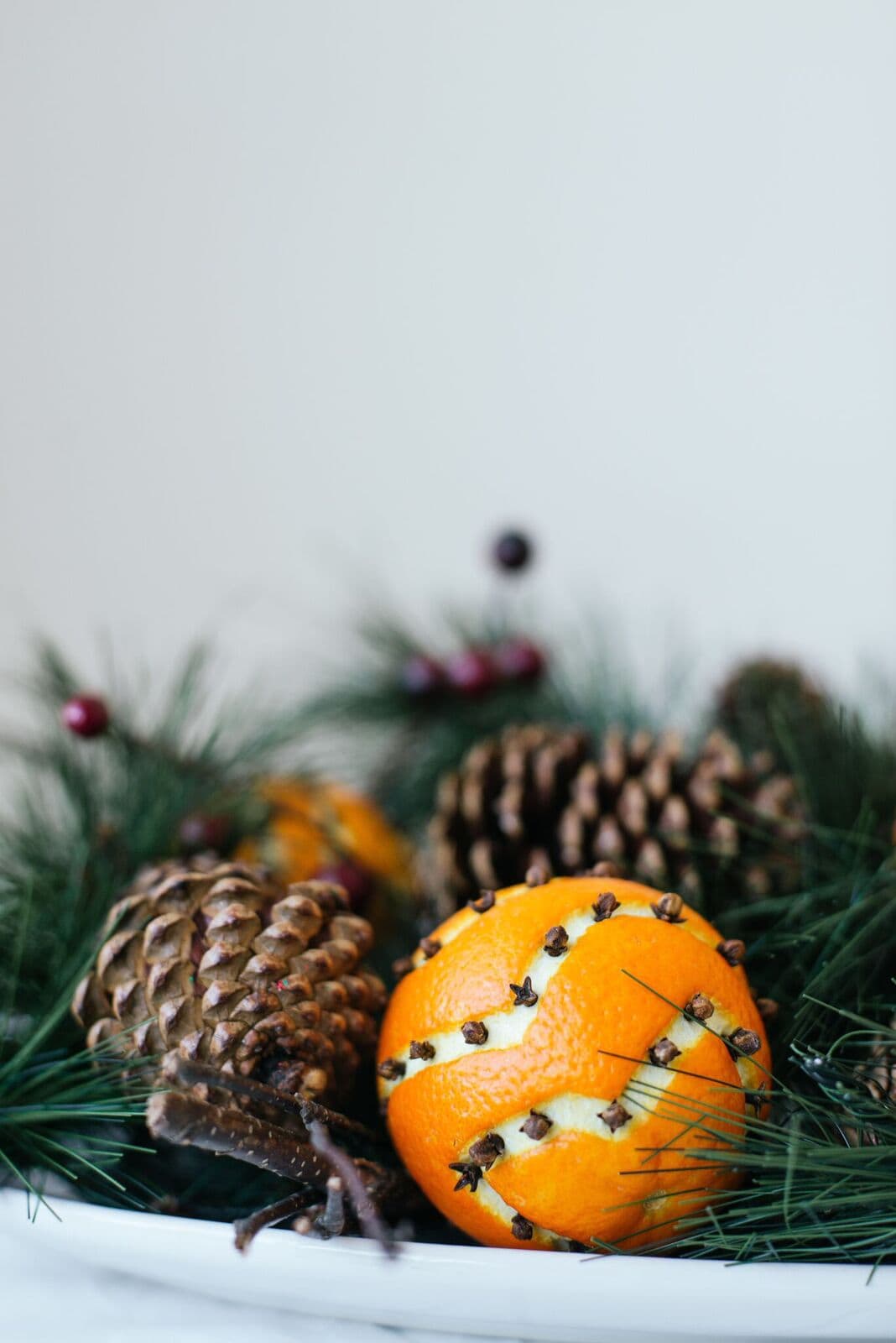 decorative fruit diy showcasing transition from Thanksgiving to Christmas decor featuring orange and cloves