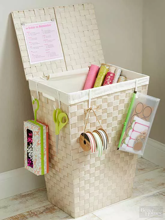 Gift wrapping station ideas for the holidays featuring a wrapping paper rolls on baskets
