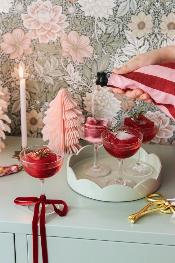 Pink Christmas Decorations inspiration, showcasing a bar in holiday decor with retro red, pink and sage green colors. .